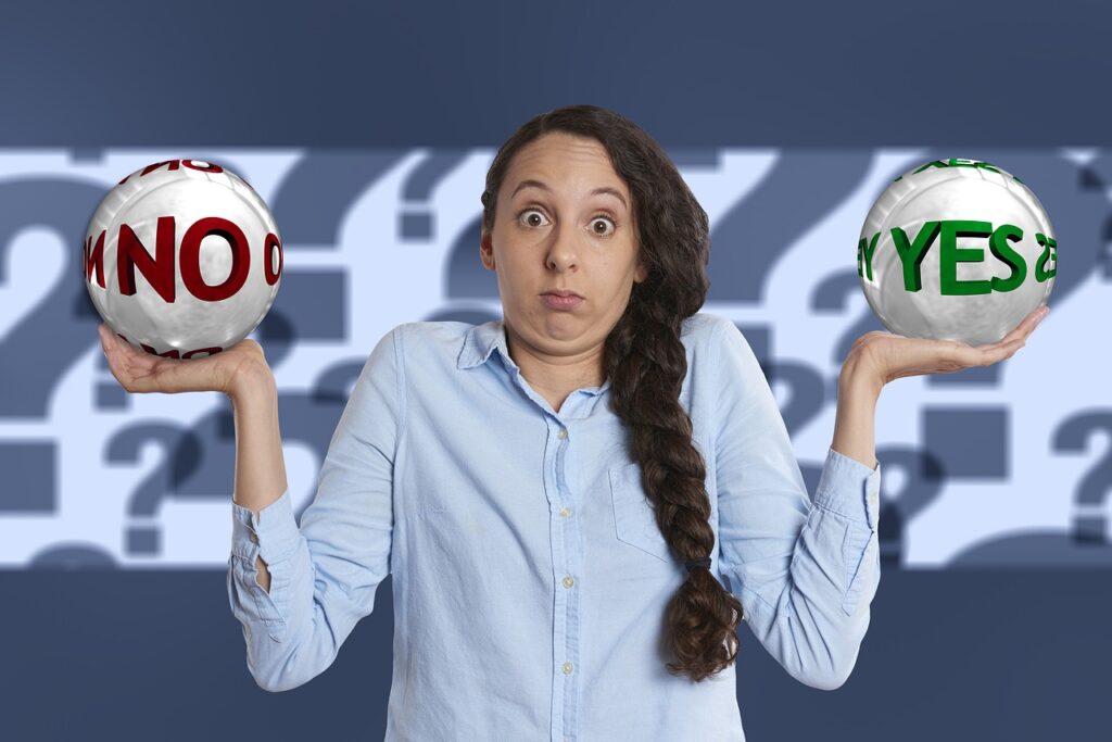 Woman holding yes or no balls