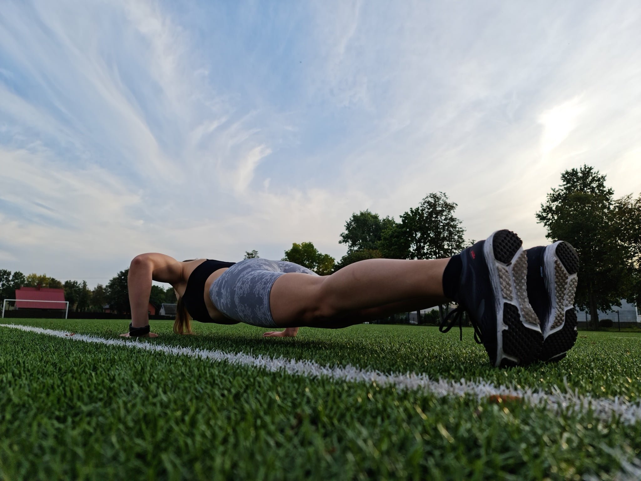 a person doing burpees in the field